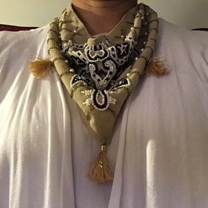 Beige scarf with faux pearl and black beads.